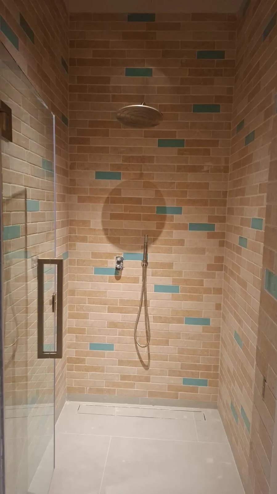 Brick Effect Tiled Shower with Glass Screen – Tiling & Tile Fixing in Dubai by Pasupati Technical Services