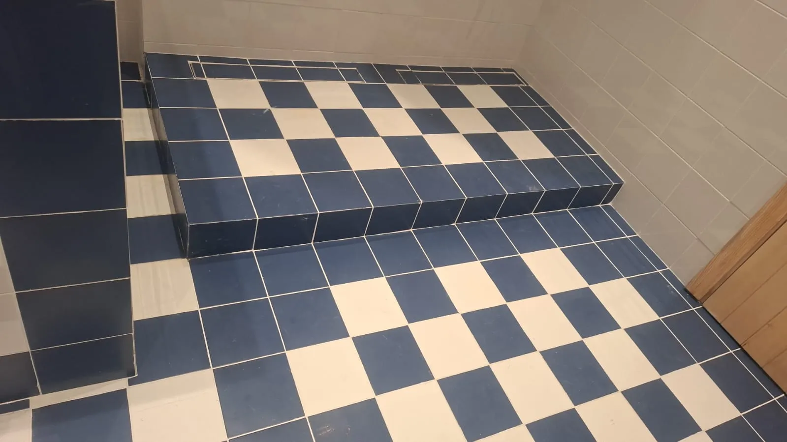 Checkerboard Tiled Shower Step – Tiling & Tile Fixing in Dubai by Pasupati Technical Services